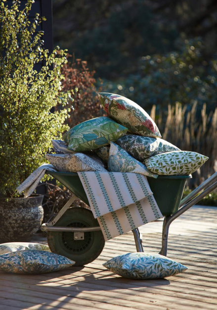 A wheelbarrow filled with lots of pillows