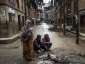 File: Local residents warm themselves by a fire in the street in Bhaktapur on April 30, 2015 in Kathmandu, Nepal.