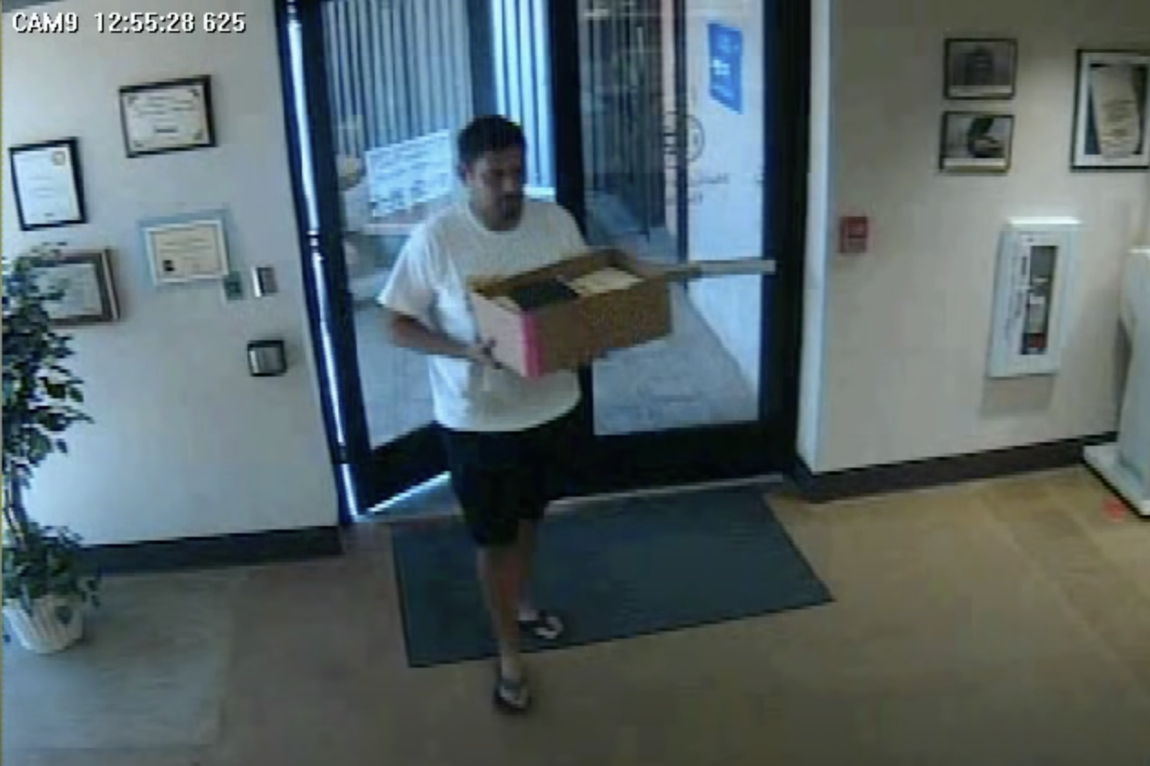 Man returning ballots to an Arizona elections office.