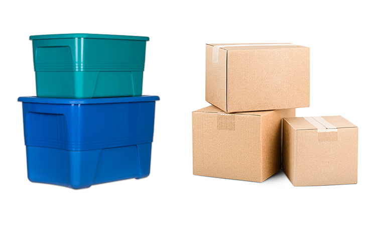 Two colorful plastic bins stacked one on top of the other beside three cardboard moving boxes.