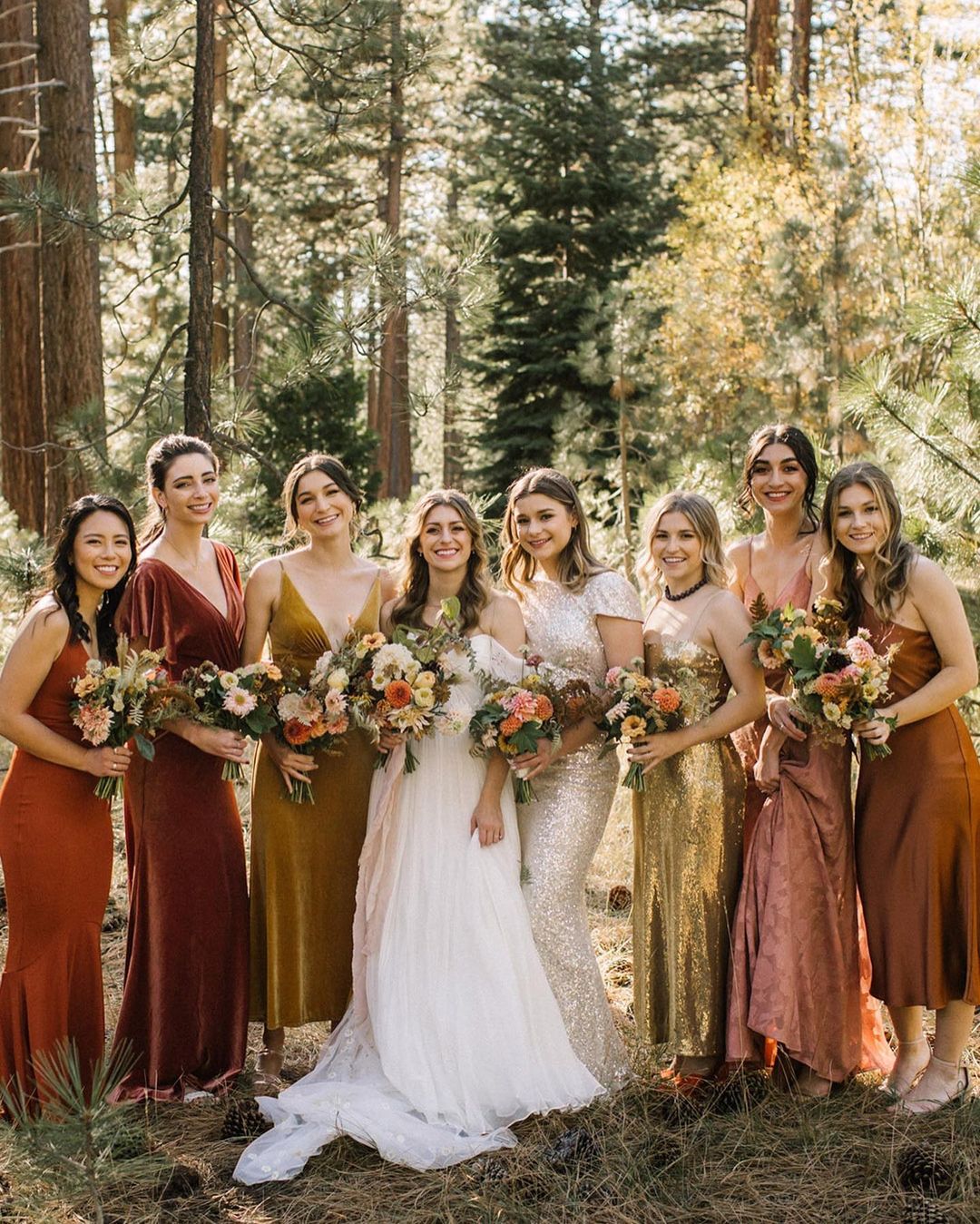 The bride and her bridal party in mix and matched bridesmaid dresses.