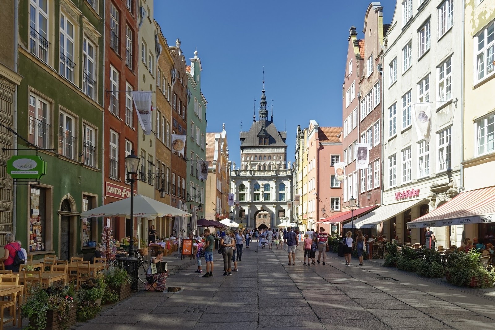 gdansk old town in summer colorful medieval buildings cobblestone road people restaurants poland