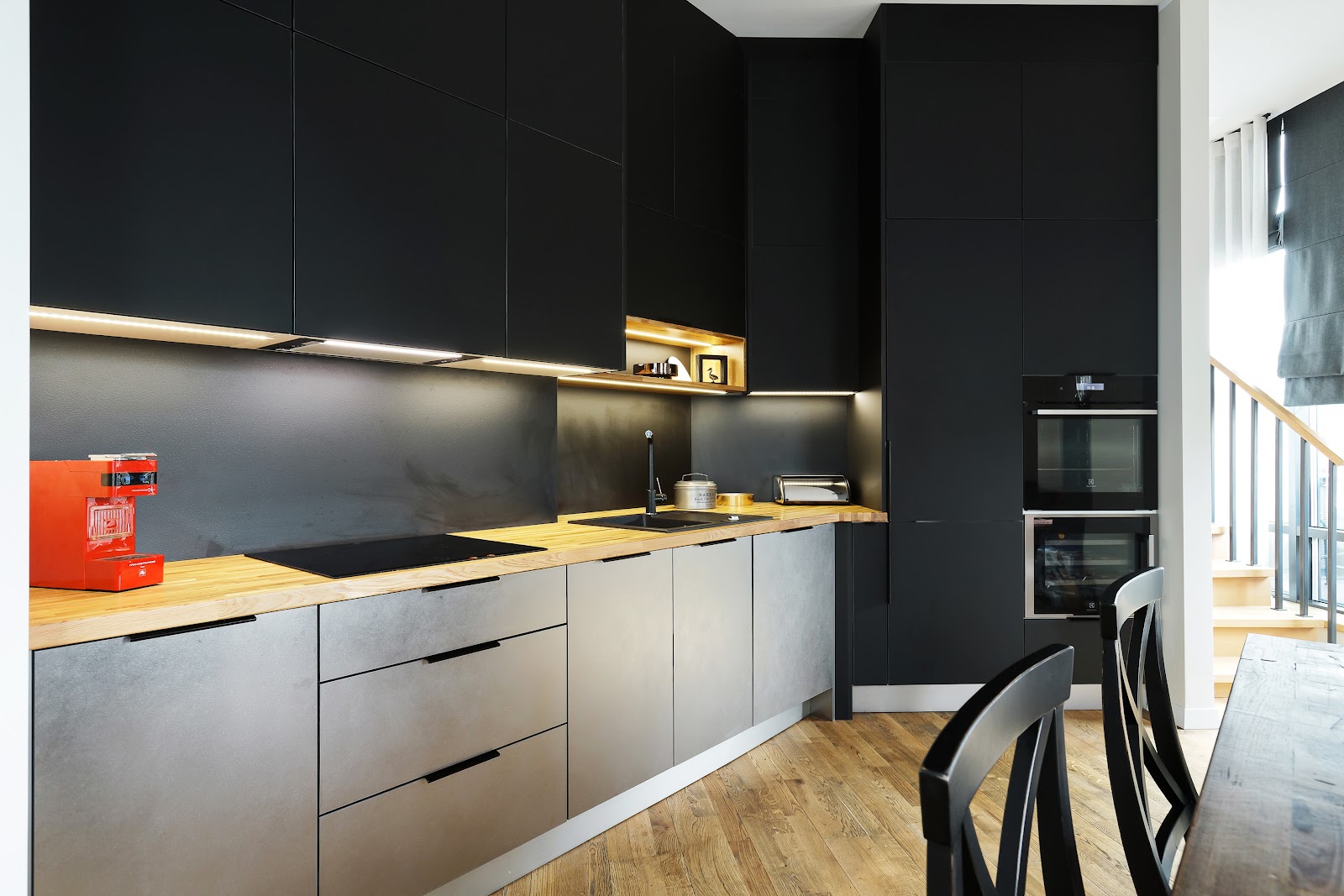 Black kitchen with wall panel
