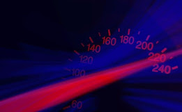 A blue and red speedometer showing the needle of 220 miles per hour.