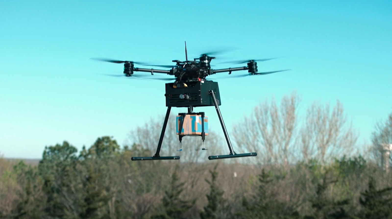 A drone transports a package through Walmart’s DroneUp delivery network. Image used courtesy of Walmart