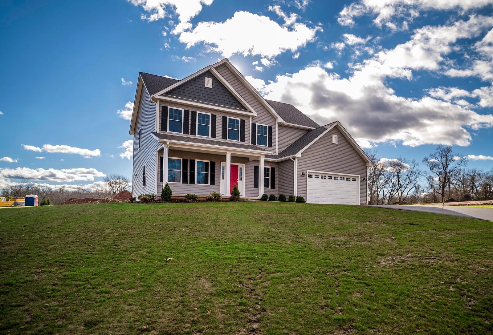 beautiful grey home with a lot of land