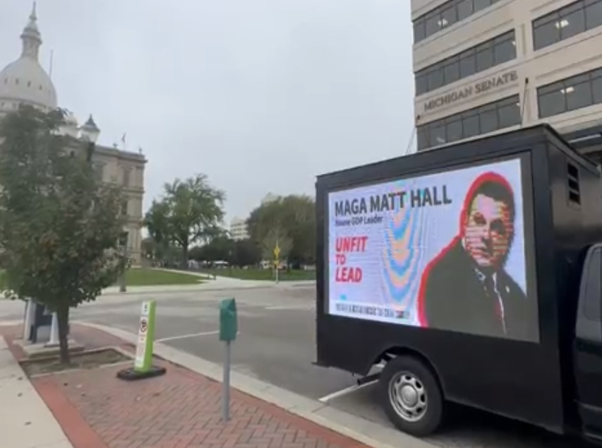 Photo of mobile billboard of Matt Hall ad outside Michigan Senate building 