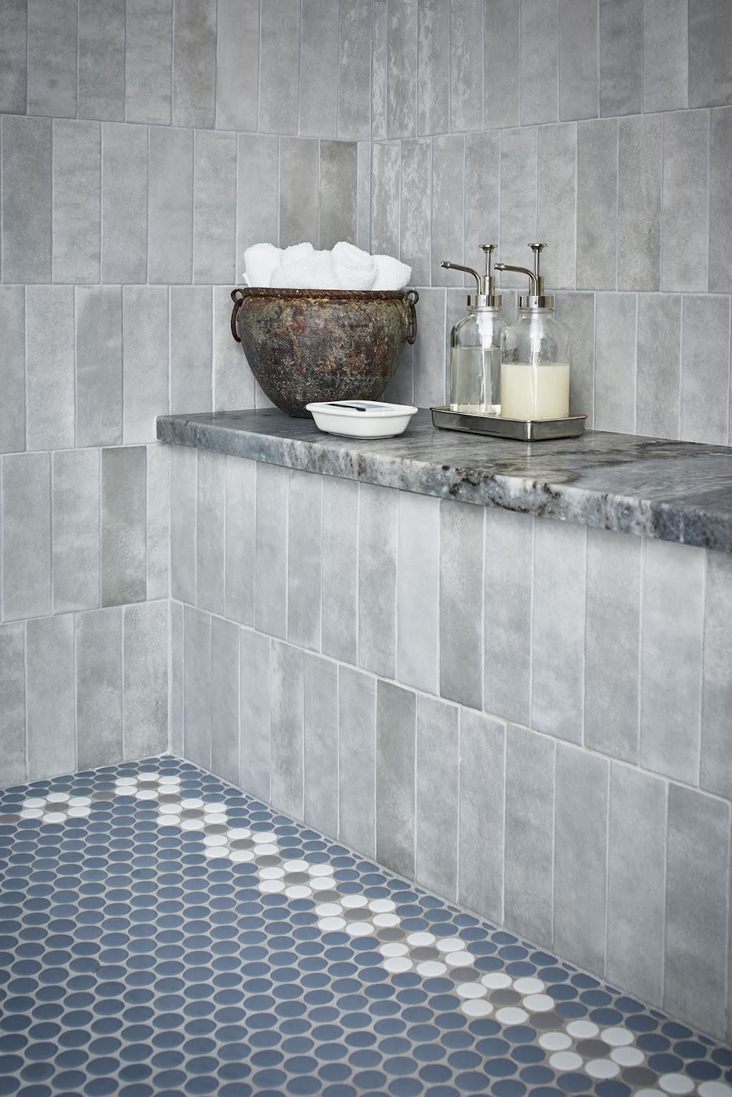 Walk-in shower with blue tile and gray stone 