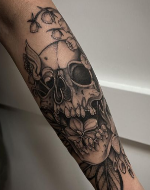 Skull With Poisonous Flower Lily Of The Valley Tattoo
