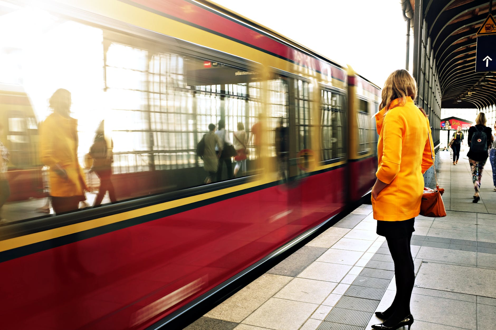 woman looking at busy train on commute to work