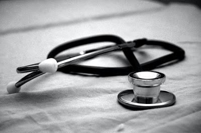 A black stethoscope on a white background