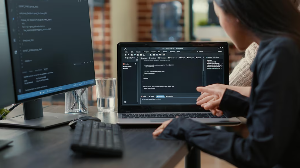 woman pointing at source code on the screen