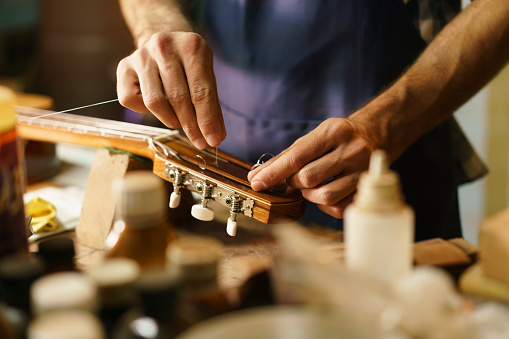 Craftsmen working on a guitar