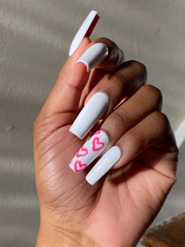 Full picture showing a white nails with a touch of pink hue in rose designs