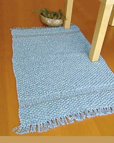 light blue knitted rug on floor