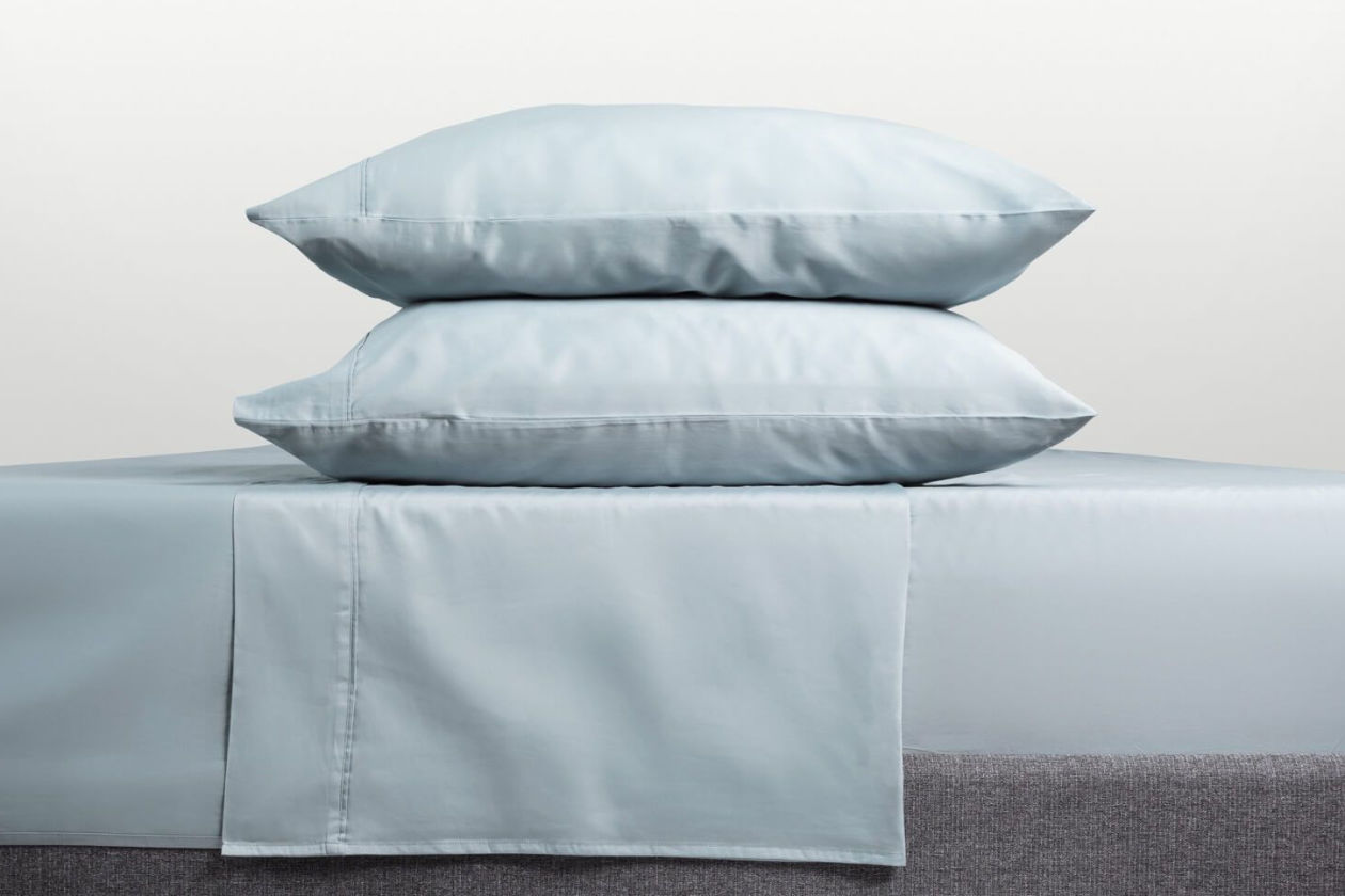 Light blue sheets and pillowcases on beds