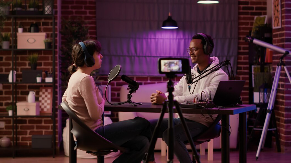 two people sitting at the table and talking in purple room