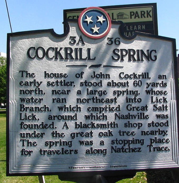 Large metallic marker that reads: "Cockrill Spring, The house of John Cockrill, an early settler, stood about 60 yards north, near a large spring, whose water ran northeast into Lick Branch, which emptied Great Salt Lick, around which Nashville was founded. A blacksmith shop stood under the great oak tree nearby. The spring was a stopping place for travelers along Natchez Trace."