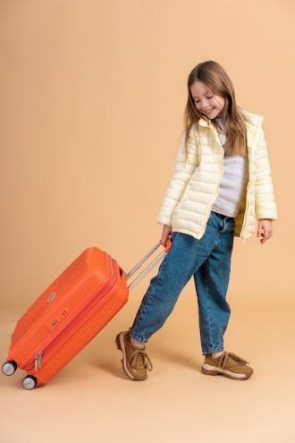 Free photo young girl holding luggage ready for travel vacation