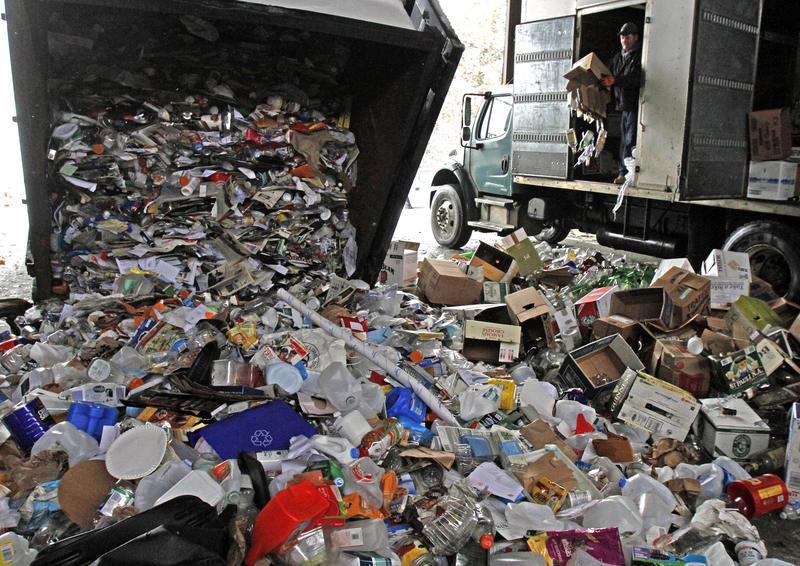 Trucks dumping plastics and recyclables