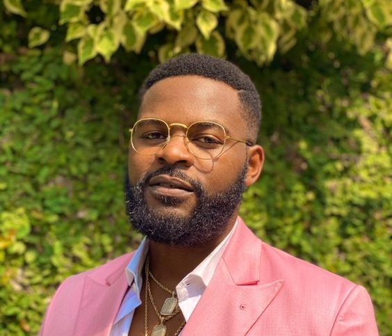 Falz in a pink suit wearing his signature style glasses without lens