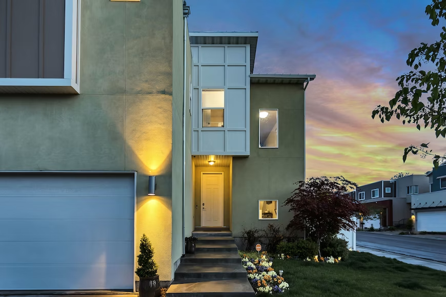 A modern home with lights on near the doors