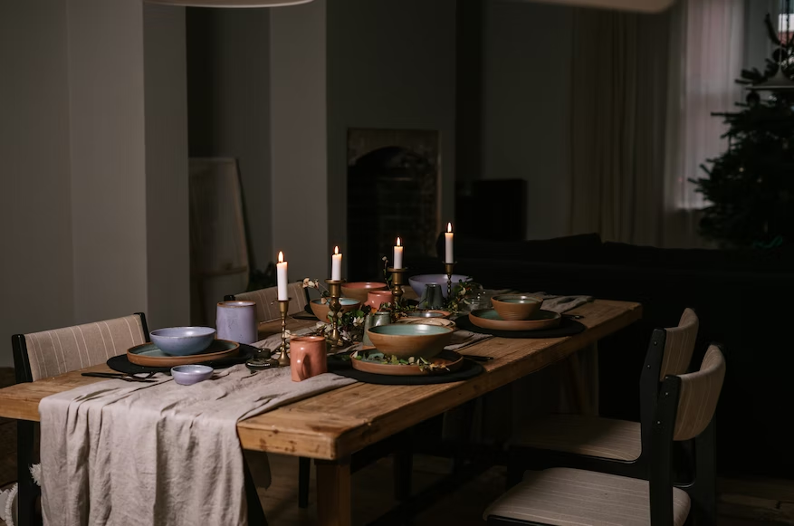 A dining table with candles and bowls