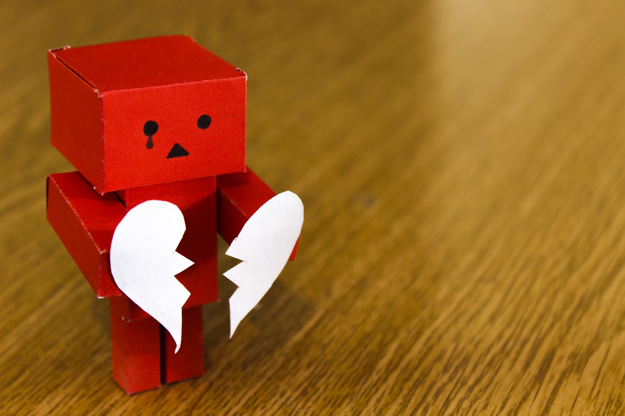 A picture of a cardboard character holding a broken heart, introducing the lyric—you break my heart