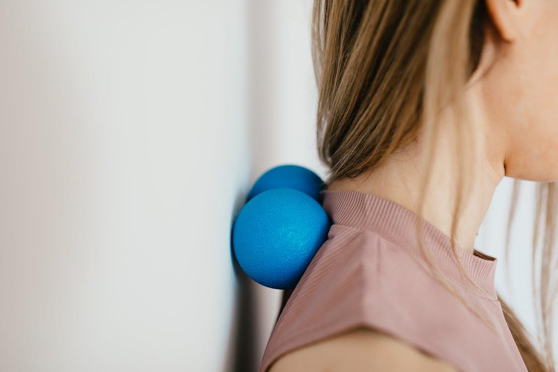 Free Close-Up Photo of a Woman Pressing Her Neck on a Stress Ball Stock Photo
