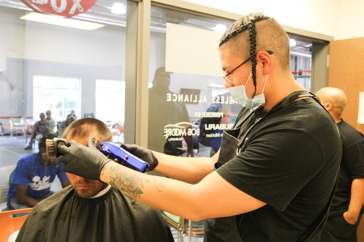 A person getting a haircut at a barber shop

Description automatically generated