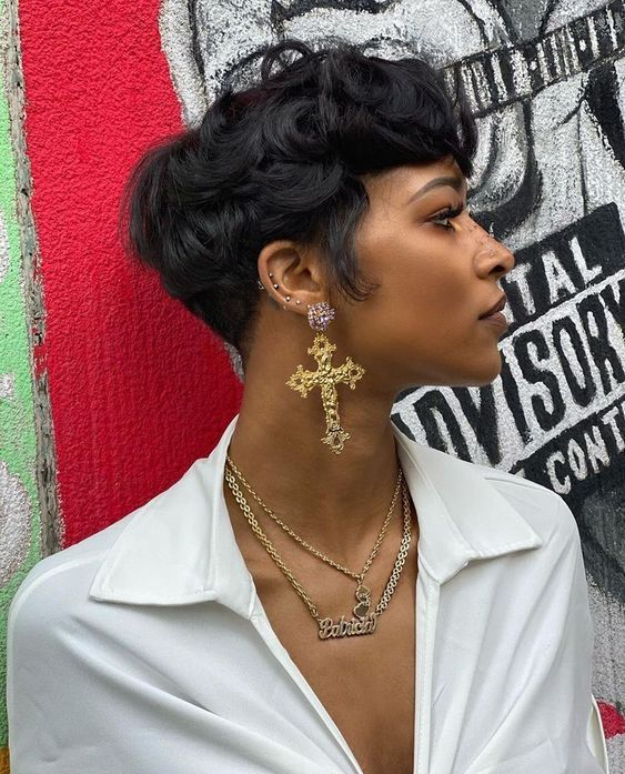 lady with cross earrings wearing pixie cut 