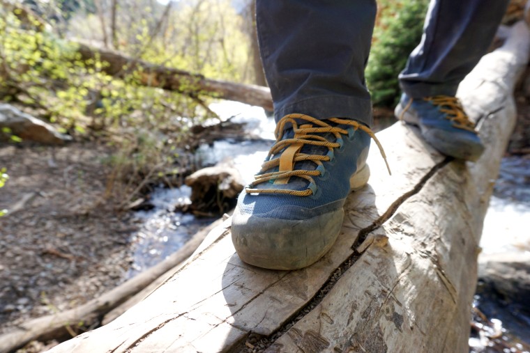 Black Diamond Mission LT Approach Shoes in action on a log crossing.