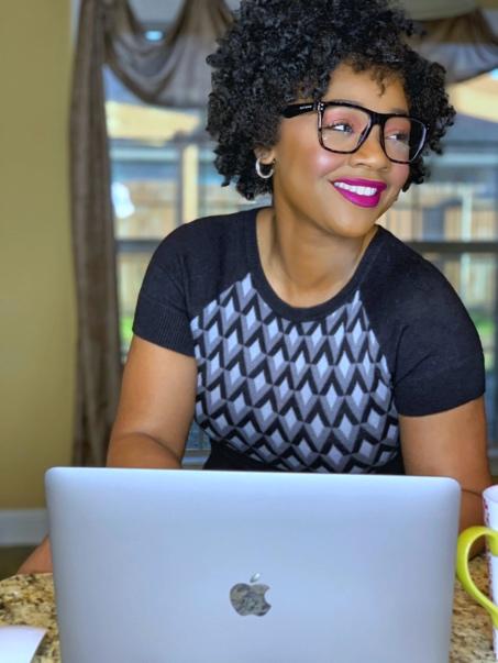 African American woman working on computer smiling