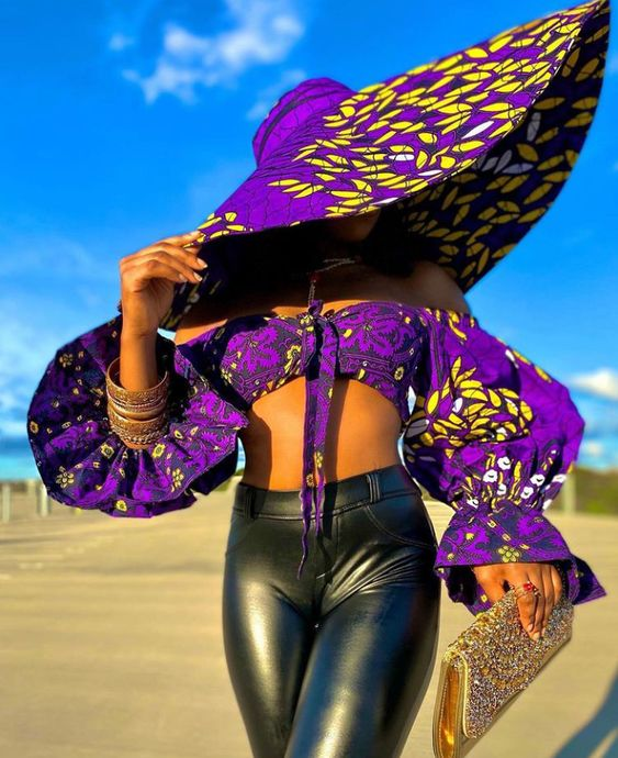 lady wearing wide-brimmed ankara hat with matching top and black leather pants