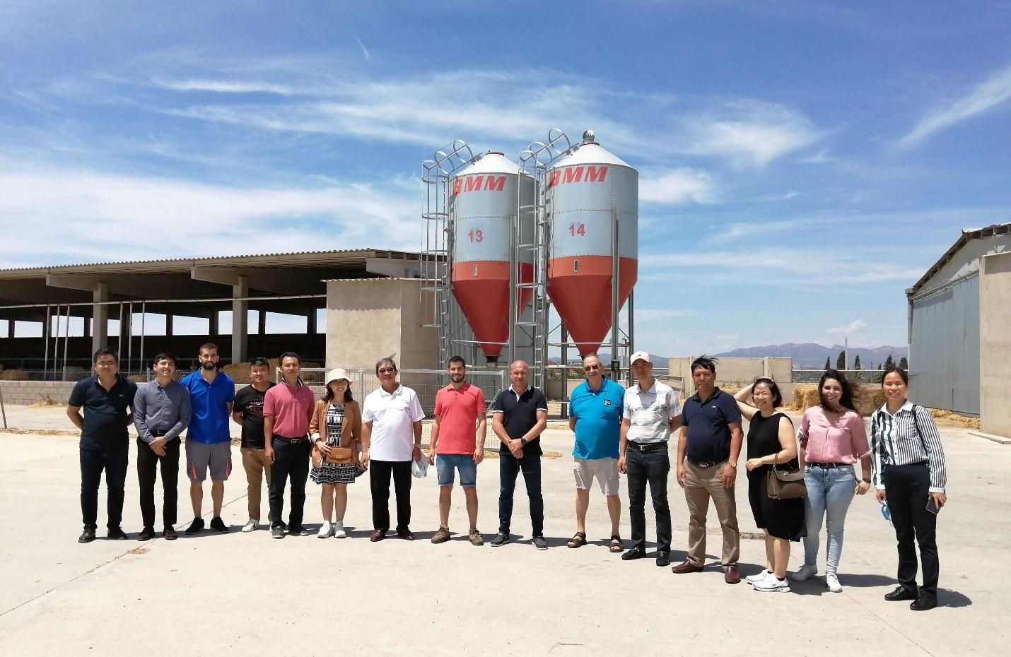 A group of people standing in front of a water tower

Description automatically generated with medium confidence