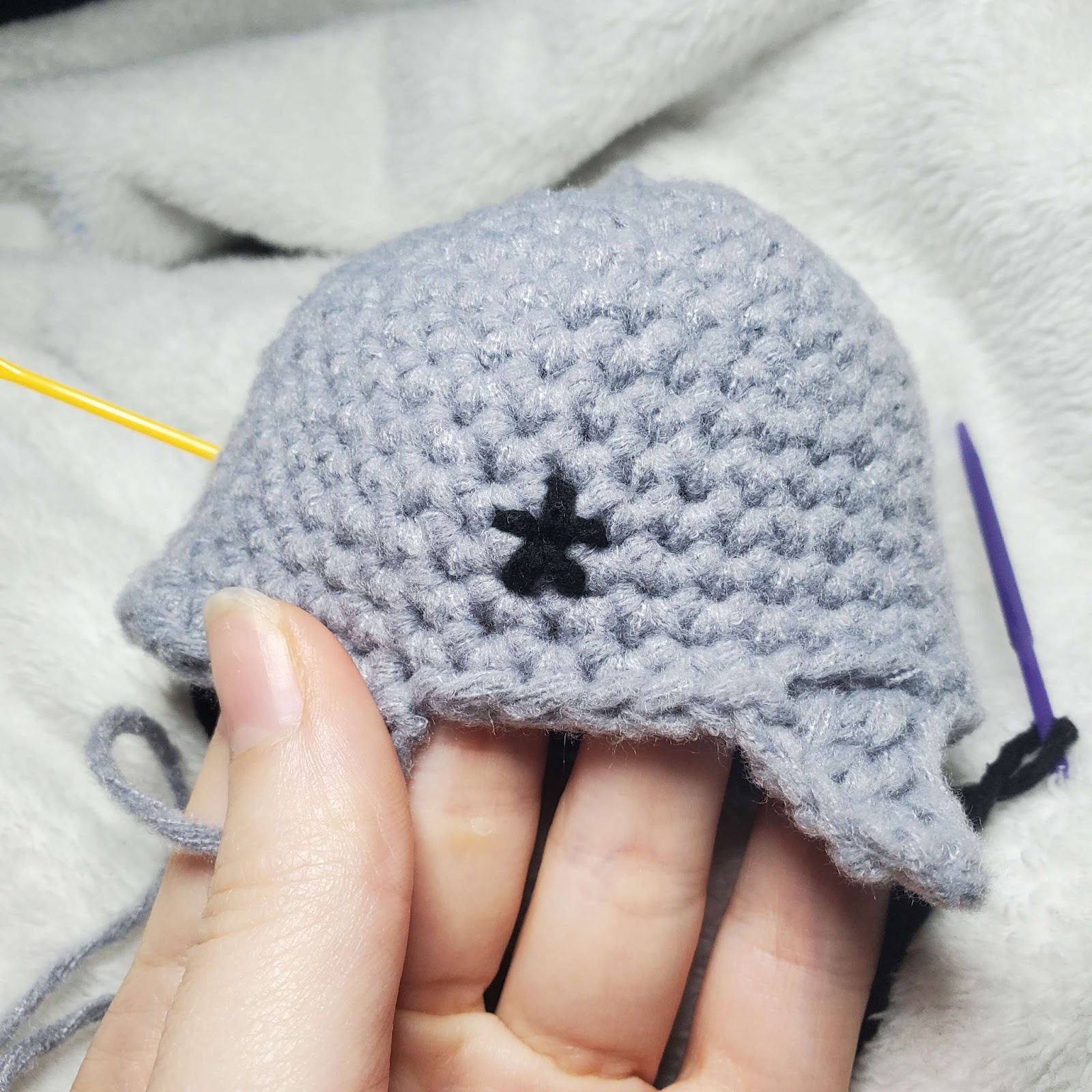 Image shows how to start the crochet shark lovey embroidery of the eye. 
