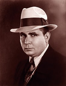 Professional photograph of Robert E. Howard wearing a hat and suit.