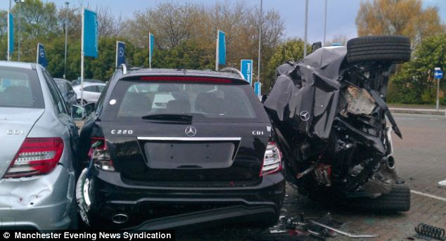 Domino effect: The £60,000 BMW X6 is believed to have flipped over on to its roof before skidding on to the forecourt of the showroom