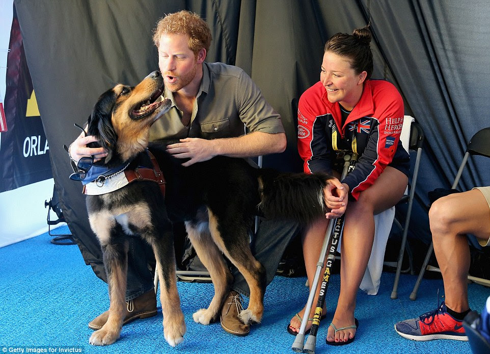 As well as finding time to talk to the men of the Invictus Games, Harry also took time to enjoy the company of man's best friend as he was seen petting a dog in the competitors tent