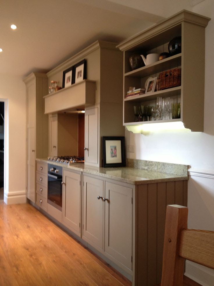 Farrow and Ball Mouses Back lowers, lightened Light Grey uppers, surf green granite, copper back splash. Medium oak floors.