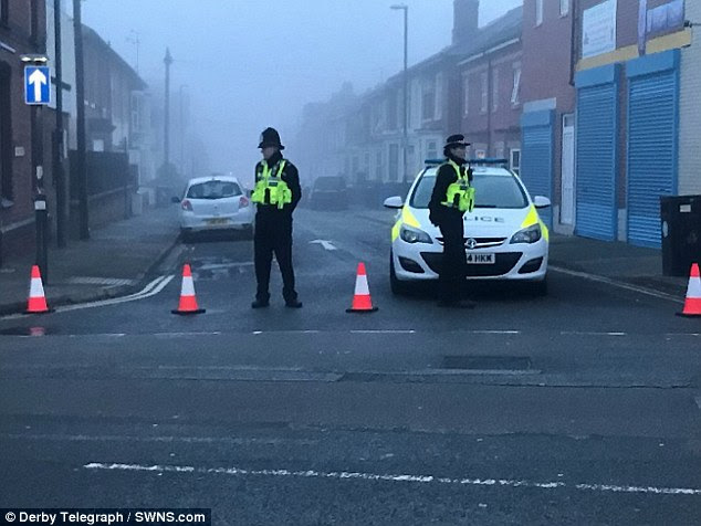 Six people were arrested on suspicion of terrorism offences in series of morning raids across England. Police are pictured in a street in Derby where some of the arrests took place