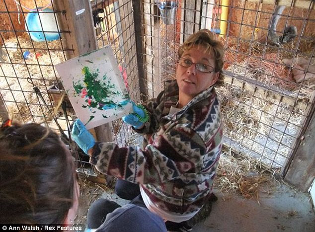 Monkey masterpiece: Sherri Delaney, founder of Story Book Farm primate sanctuary in Canada, poses with one of Pockets Warhol's works