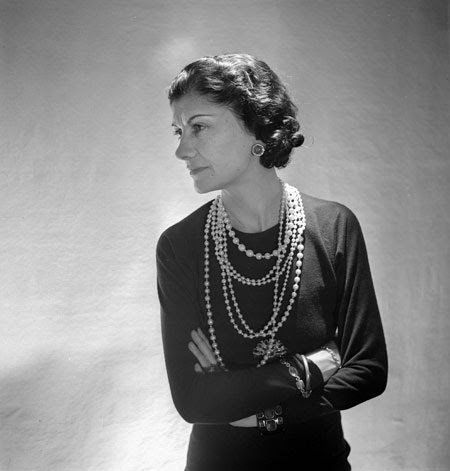 Coco Chanel wearing strands of faux pearls