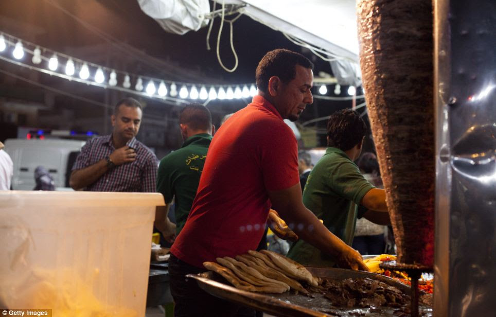 Hungry: A street vendor makes shwarma (lamb) sandwiches in Baghdad