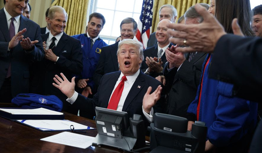 President Donald Trump speaks in the Oval Office of the White House in Washington, Tuesday, March 21, 2017, after signing a bill to increase NASA's budget to $19.5 billion and directs the agency to focus human exploration of deep space and Mars.  (AP Photo/Evan Vucci)