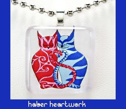 red and blue cats in a glass pendant necklace