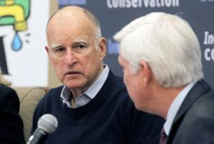 California Governor Jerry Brown, left, talks with General …