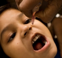 A child from a nearby village visits the Polio Booth to get inoculated on National Immunization Day in Moradabad, India, 2007.