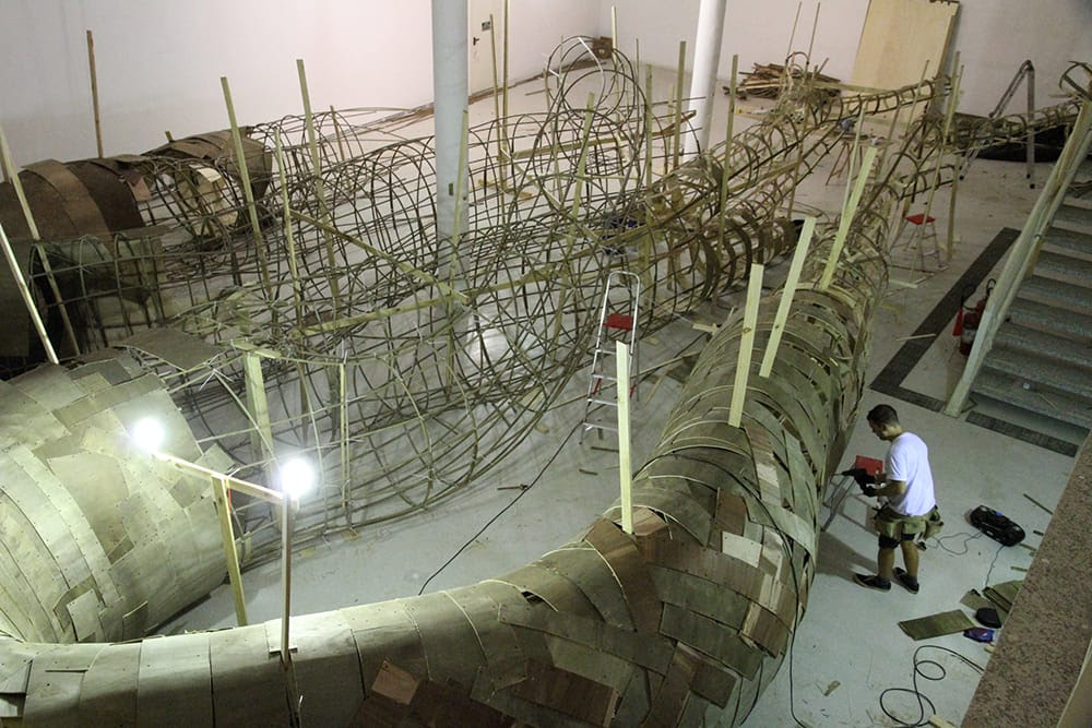 Artist Henrique Oliveira Constructs a Cavernous Network of Repurposed Wood Tunnels at MAC USP Artist Henrique Oliveira Constructs a Cavernous Network of Repurposed Wood Tunnels at MAC USP wood installation architecture