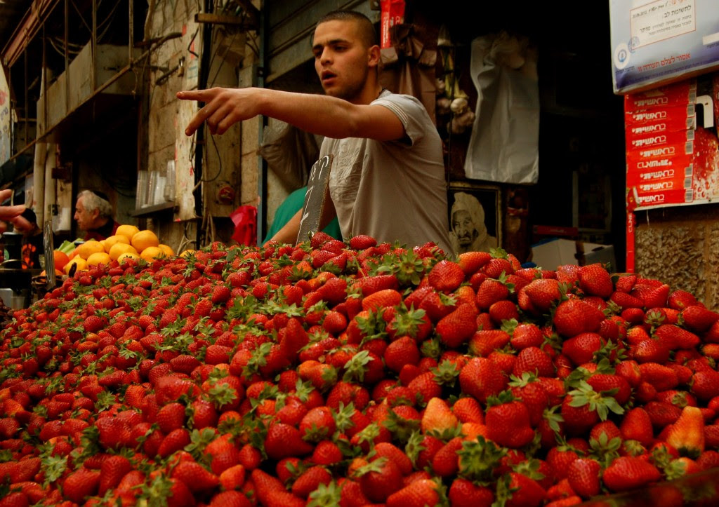 Israeli selling strawberries at a market